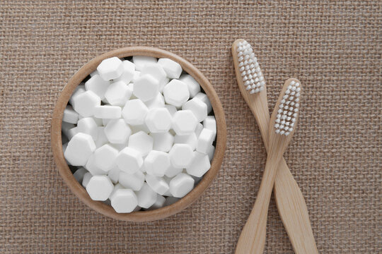 White solid toothpaste tablet with bamboo toothbrush