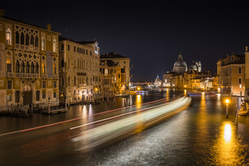 Fototapeta na wymiar Amazing shot took in Venice Canal Grande at night - Long exposure of boat's light