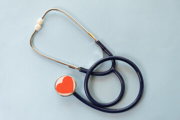 Red stethoscope and phonendoscope with chrome chestpiece carries out survey. Concept for protection, treatment and prevention of heart from diseases of cardiovascular system