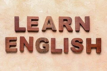 Text LEARN ENGLISH on grunge beige background