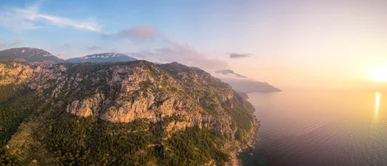 Foto op Canvas Mallorca Port de Valldemossa, aerial view of the mountains and sea at sunset, scenery of a coastline with beautiful cliffs, aerial montage with red sunset, Landscape from above the water, travel vibes © tt_pix