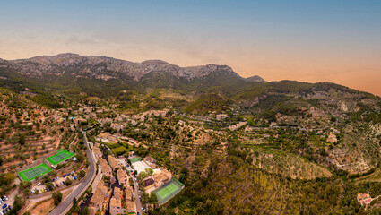 Aerial view of the mountain town Déia, Sunset on the Island of Mallorca in Spain, in the style of high dynamic range, Beautiful Mountain skyline in Serra de Tramuntana, travel vibes, summer time