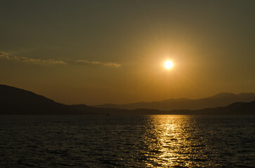 Evia island, Greece - July 01. 2020: Sunset on the island of Evia, Greece. Panoramic view of the sunset on the Greek island of Evia in the Aegean Sea.