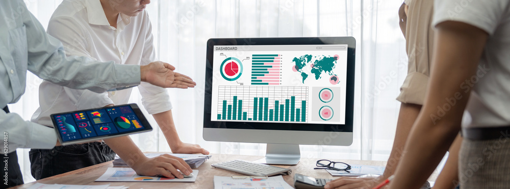 Poster Panorama shot analyst team utilizing BI Fintech to analyze financial report with laptop. Businesspeople analyzing BI power dashboard displayed on laptop screen for business insight. Scrutinize