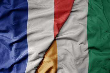 big waving realistic national colorful flag of france and national flag of cote divoire .
