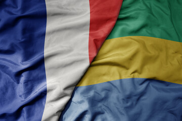 big waving realistic national colorful flag of france and national flag of gabon .