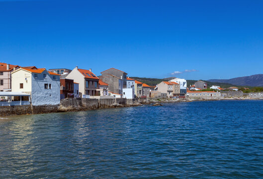 Houses on the sea in the town of Corrubedo. A Coruña, Galicia, Spain.