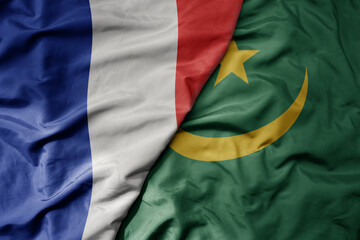 big waving realistic national colorful flag of france and national flag of mauritania .