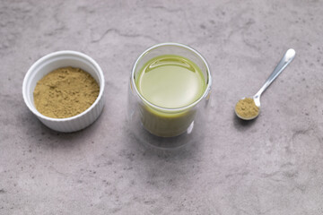 Top View Glass Of Smoothie, Juice With Hemp Protein Powder On Table. Bowl And Spoon With Plant Derived Protein from Cannabis Plant. Superfood, Dieting. Horizontal Plane Flat Lay