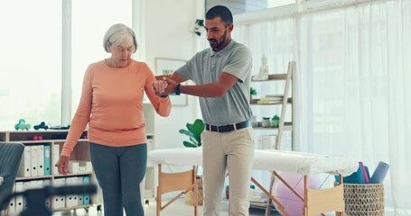 Man, physiotherapy and patient walking in elderly care for physical therapy or assessment at the clinic. Male medical physiotherapist or caregiver helping senior woman to walk in healthcare support
