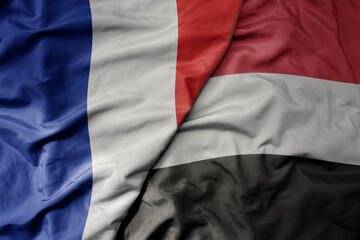 big waving realistic national colorful flag of france and national flag of yemen .