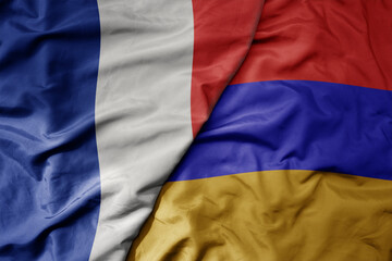 big waving realistic national colorful flag of france and national flag of armenia .