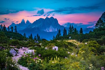 Hiking trail at Sorapis lake with mystic view on Cadini di Misurina in the background in the evening. Lake Sorapis, Dolomites, Belluno, Italy, Europe.