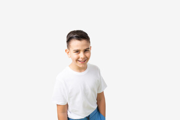 portrait of a laughing white eastern European 8 or 9 years old boy in white t-shirt - obrazy, fototapety, plakaty
