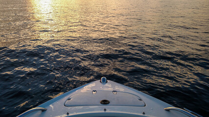 Sailboat at Sunset: Tranquil Nautical Scene on Rippling Waters with Dramatic Sky © Noah