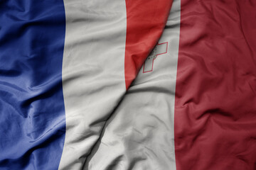 big waving realistic national colorful flag of france and national flag of malta .