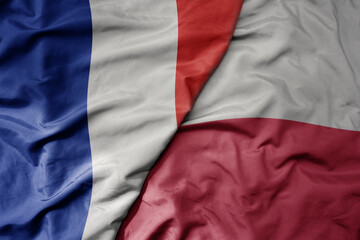 big waving realistic national colorful flag of france and national flag of poland .