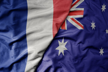 big waving realistic national colorful flag of france and national flag of australia .
