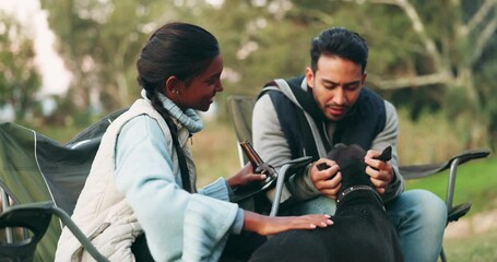 Couple, camping and relax with dog, forest and talk with smile, drink beer and love for nature holiday. Man, woman and pet animal with stroke, care and happy together in woods, park and countryside