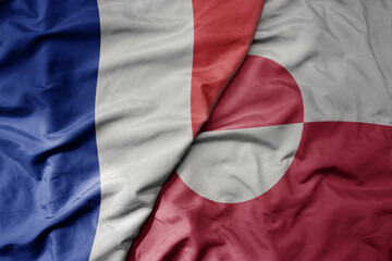 big waving realistic national colorful flag of france and national flag of greenland .