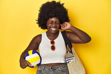 Beach-ready woman with volleyball, ready for sport covering ears with hands.