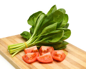 Fresh leaves of spinach on white