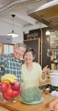 Asian elderly couple in kitchen