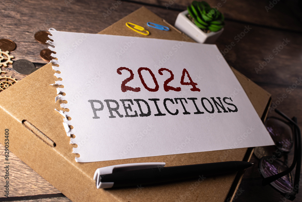 Poster 2024 predictive analytics text on yellow sticker on white keyboard.