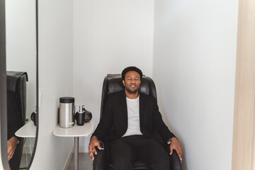 Dreamy relaxed business man rest after finished work in comfortable massage armchair