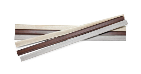 Many pieces of wooden baseboards isolated on white, top view
