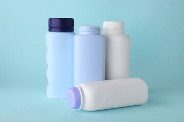 Baby powder in bottles on turquoise background. Space for text