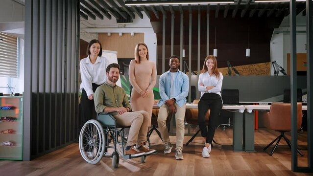 Workers of different nationalities smiles standing in office