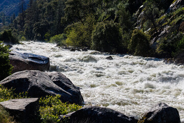 Raging Merced River from snow melt at Arch Rock Entrance in Yosemite National Park in spring of...