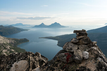 Afternoon view from Smaltinden, Luröy, Helgeland, NordNorge. View over Norwegian island of Tomma, across sjona. Mountains on islands in Norway. Tower of rocks in the foreground. Beautiful Norway hike.
