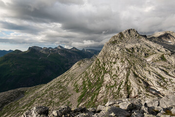 View of Breitinden and Tortenviktinden from smaltinden, Melöy, Norway during a summer thunderstorm. Hiking in Helgeland. Topptur norska fjell. Fjelltur. Dramatic mountain weather. Peak in clouds. 