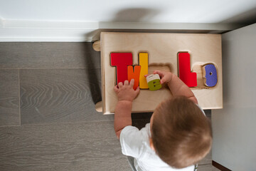 Child with toy stool and name