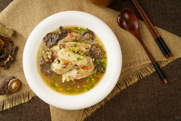 Special Chinese food stewed chicken with mushrooms on retro dark background