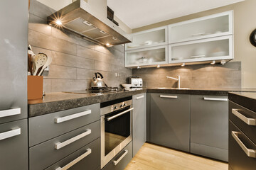 a modern kitchen with black counter tops and white trim on the cabinets in this photo is taken from an angle