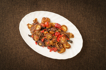 Variety of washed mountain products placed in a white porcelain dish on a monochrome background