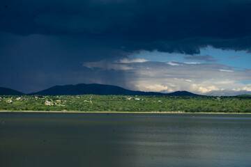 View across the lake, of the separation of the beginning of the rainfall