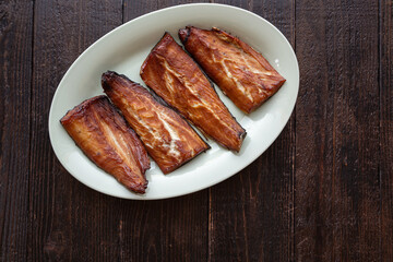 Smoked barracuda fillets on a platter