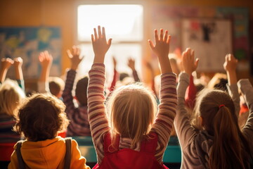 students raising their hands during class at elementary school
