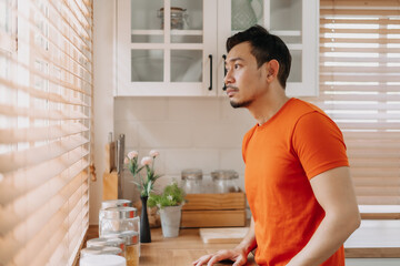 Asian man calm in the kitchen in the morning prepare his easy breakfast.