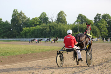 Horses and riders running at horse races