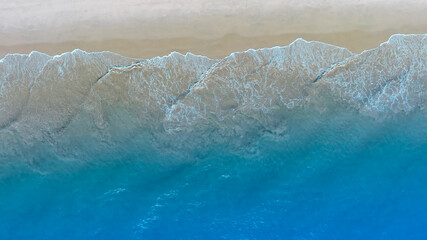 Beach Wave water in the Tropical summer beach with  sandy beach background