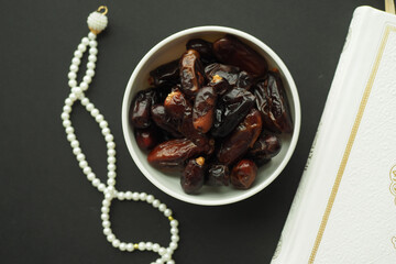 Holy book Quran and rosary on table, close up.
