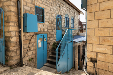Fototapeta na wymiar Stone walls of houses on a Alkabets quiet street in the old part of Safed city in northern Israel