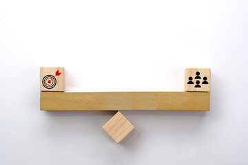 People icon and target on wooden seesaw. Concept of the balance in teamwork, collaboration and...