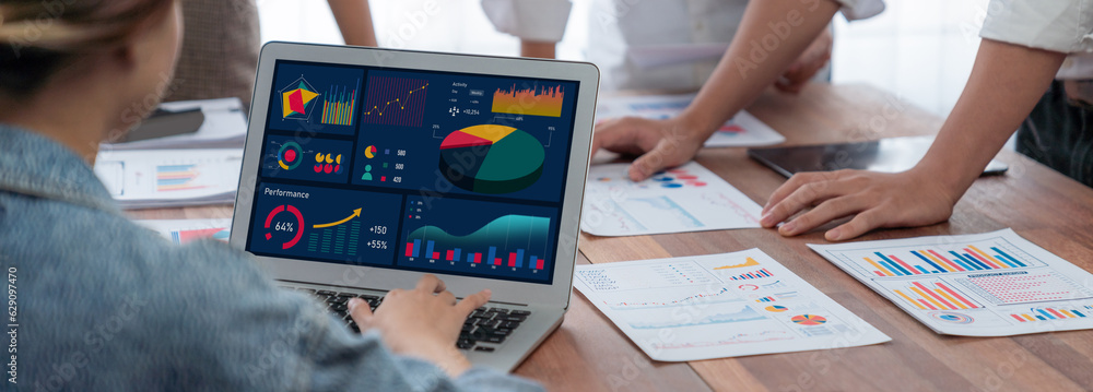 Poster Panorama shot analyst team utilizing BI Fintech to analyze financial report with laptop. Businesspeople analyzing BI power dashboard displayed on laptop screen for business insight. Scrutinize