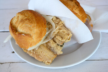 Fischbrotchen or Fish Sandwich with Brathering or Fried Herring and Onion in a Roll